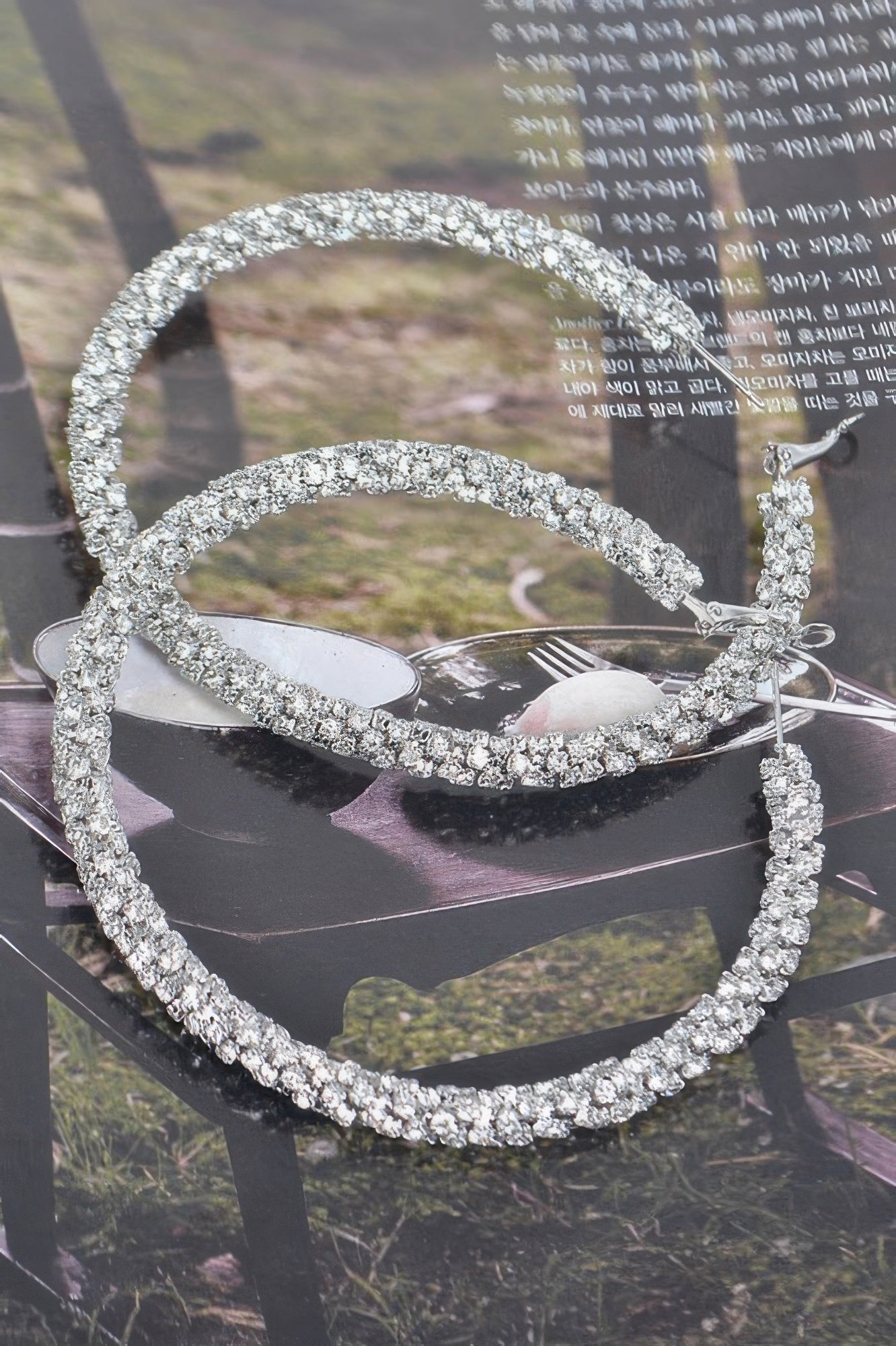 Silver-tone twisted rhinestone hoop earrings, textured pavé round hoops with clasp back