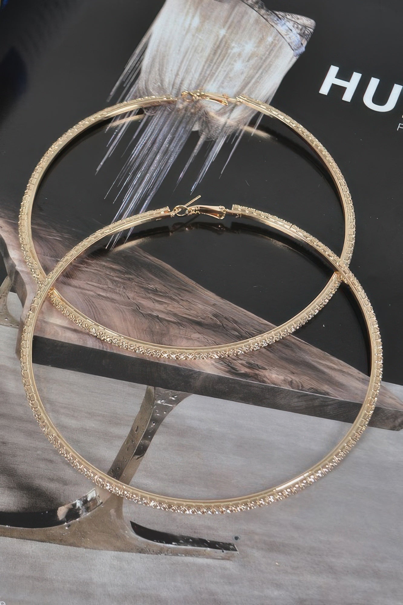 Gold-tone 10cm double hoop earrings with rhinestone edging and small center charm