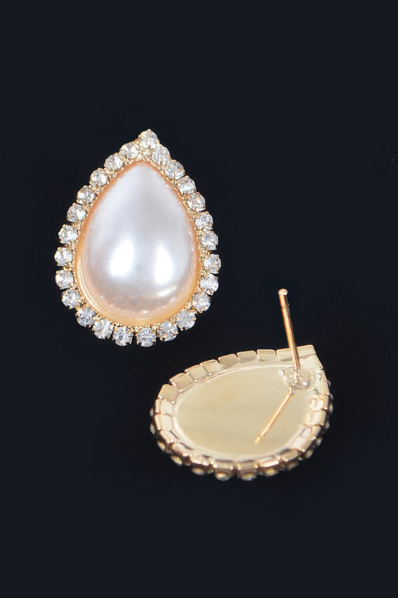 Teardrop pearl stud earrings with rhinestone halo; shows gold-tone backing posts
