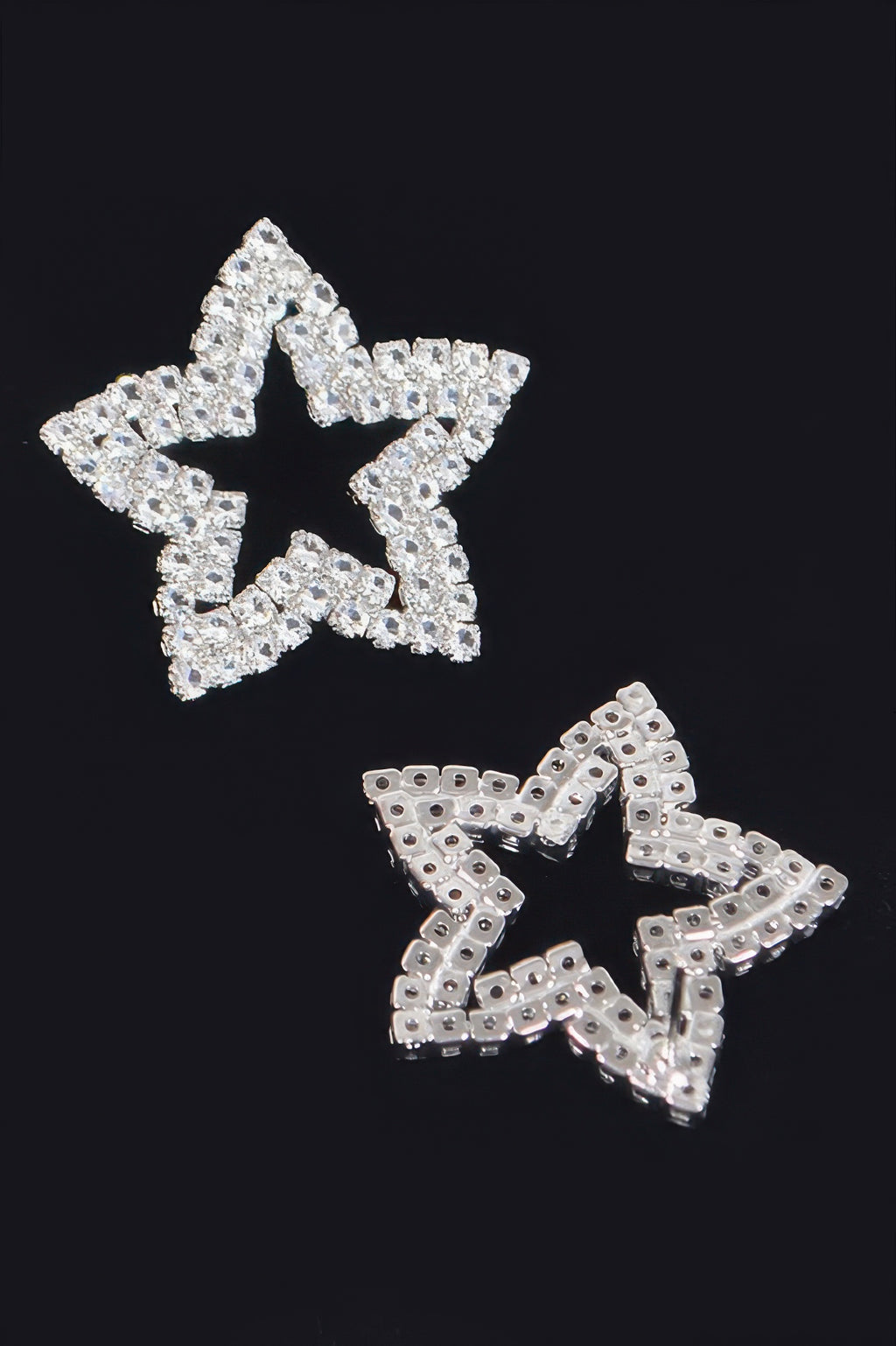Silver star rhinestone stud earrings with visible backing and post