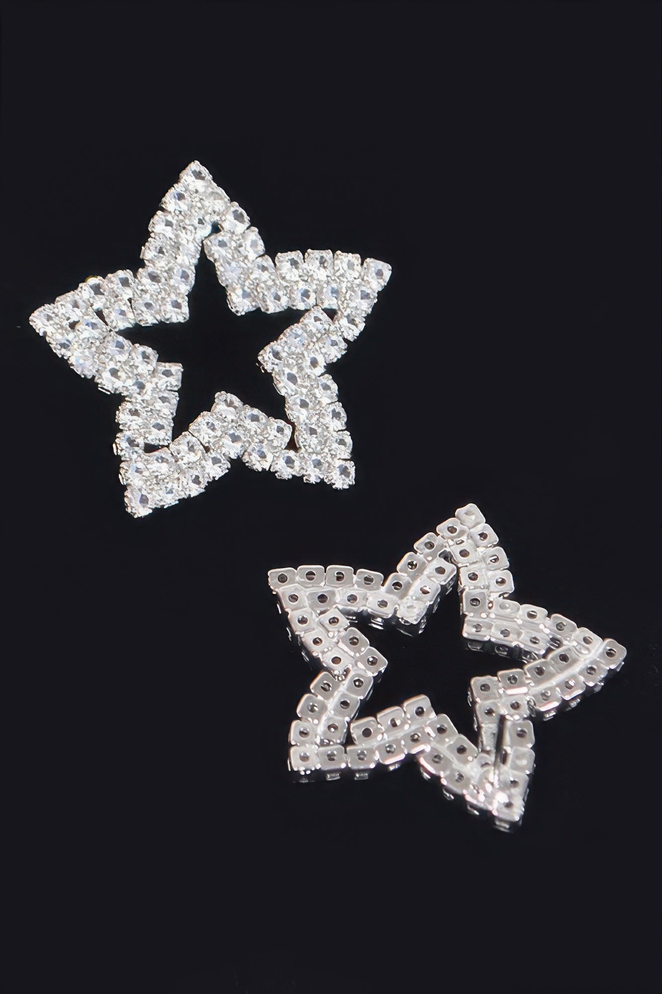 Silver star rhinestone stud earrings with visible backing and post