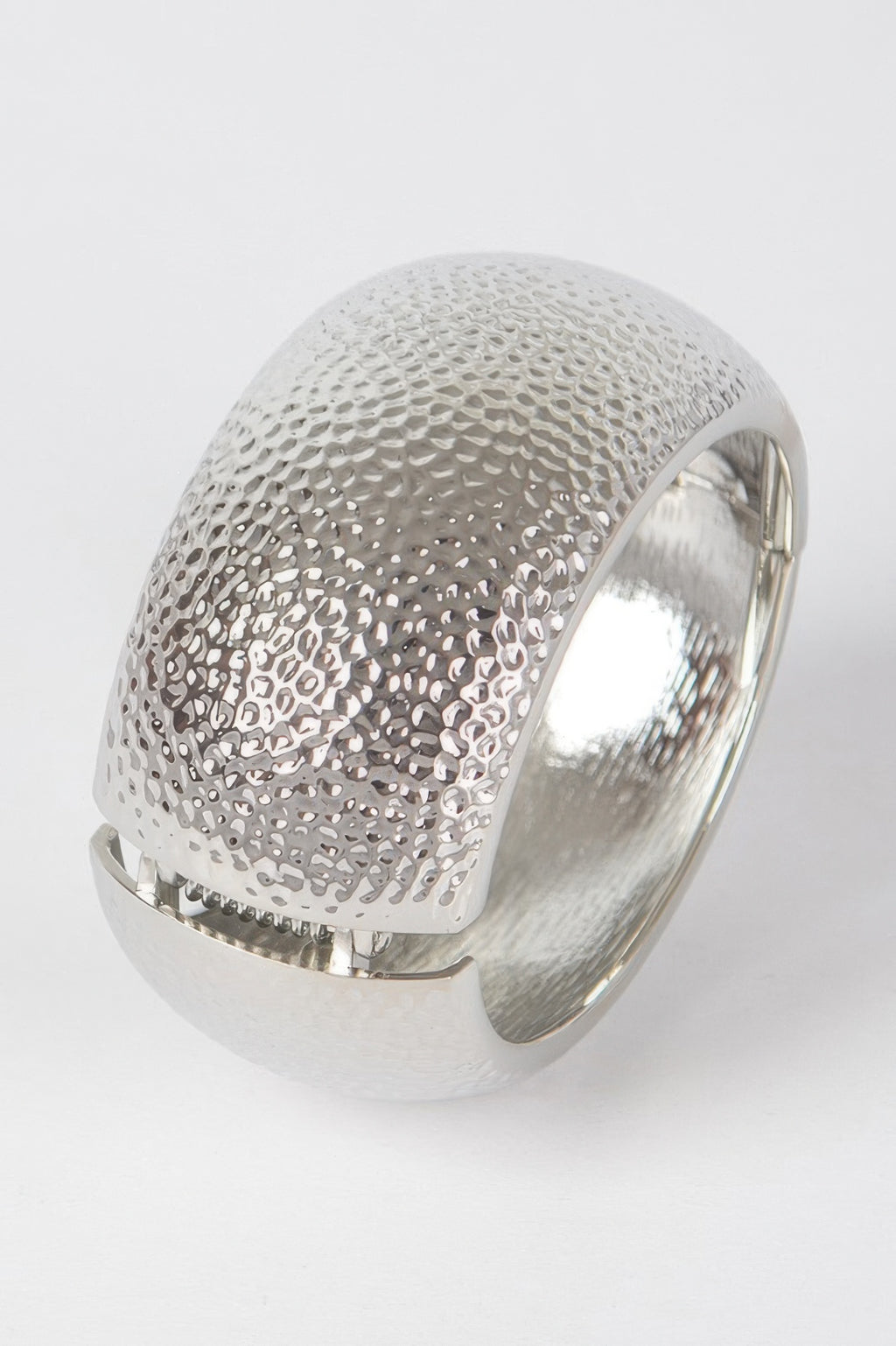 Textured silver metal bangle bracelet with raised dotted pattern, open cuff view