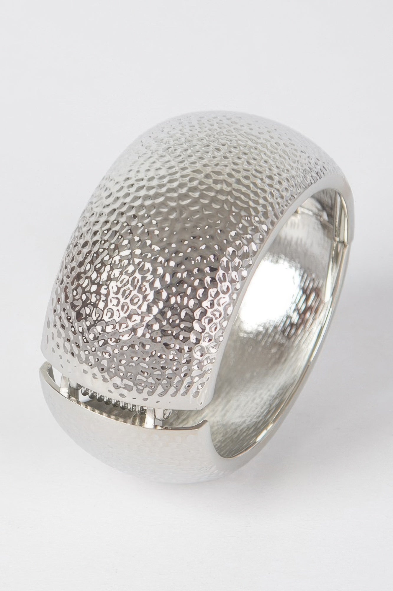 Textured silver metal bangle bracelet with raised dotted pattern, open cuff view
