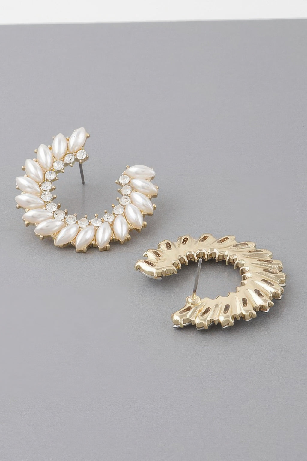 Gold-tone leaf hoop earrings with white opal-like stones and crystal accents