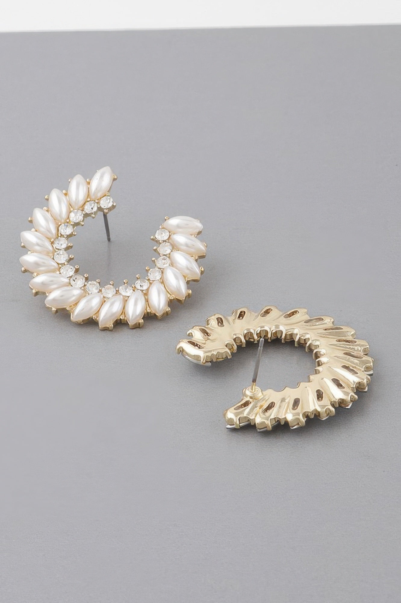 Gold-tone leaf hoop earrings with white opal-like stones and crystal accents