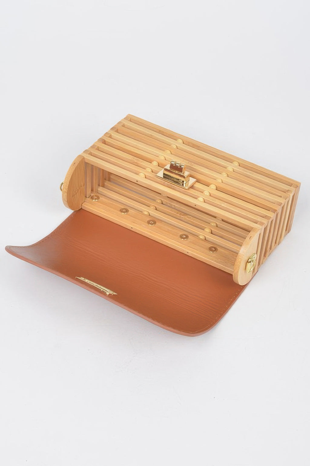 Bamboo flap crossbody bag opened, showing slatted interior and gold clasp hardware