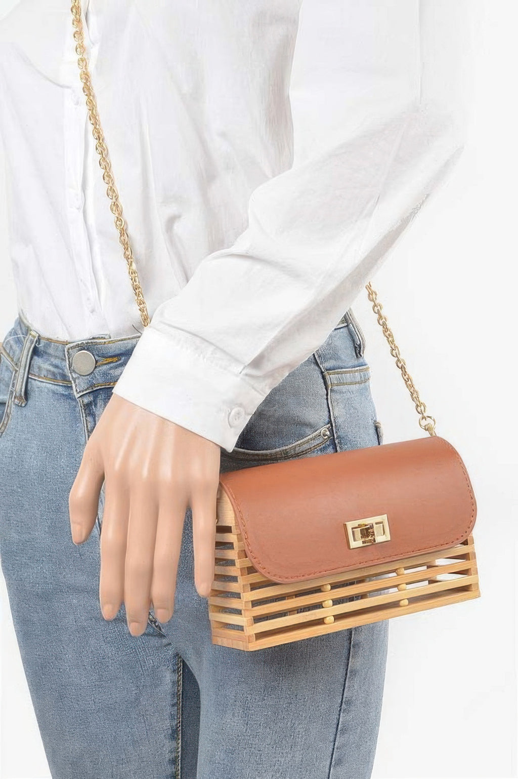 Bamboo flap crossbody bag worn on shoulder, tan-brown flap with gold clasp