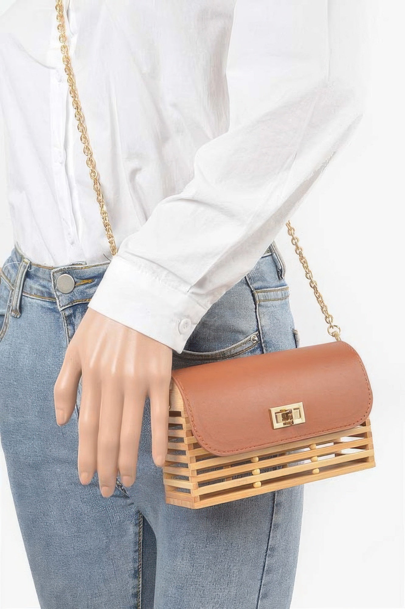 Bamboo flap crossbody bag worn on shoulder, tan-brown flap with gold clasp