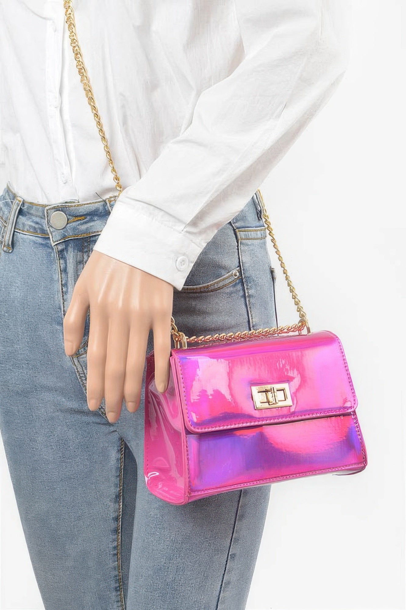 Mirror metallic flap crossbody bag, fuchsia pink, worn crossbody with gold chain strap.