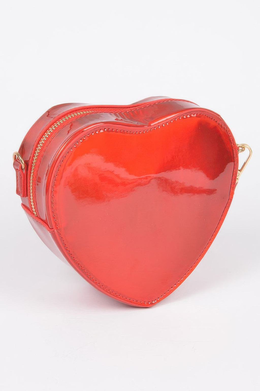 Red heart crossbody bag, front profile with curved shape and gold-trim zipper