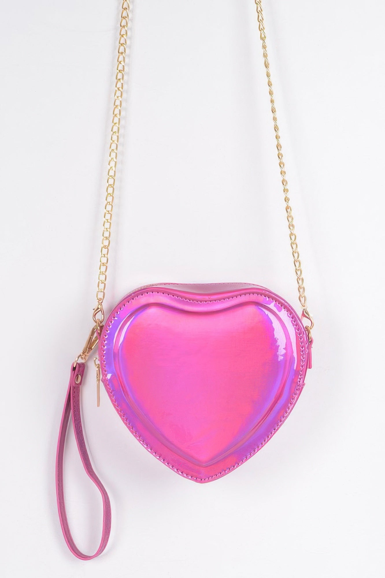 Fuchsia heart-shaped metallic crossbody bag with gold chain strap and wristlet pull