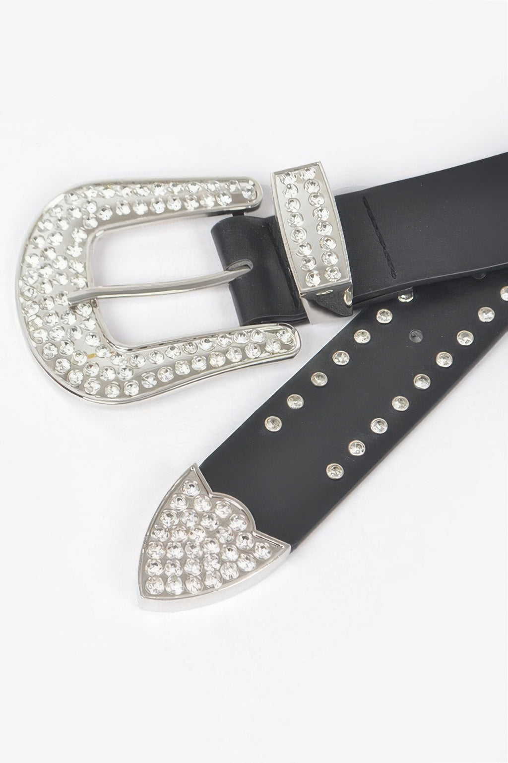 Black belt buckle detail with large silver rhinestone frame and pointed decorative end