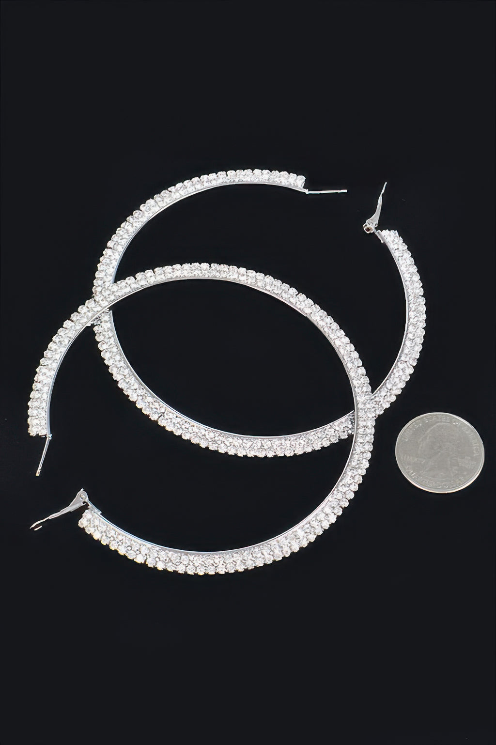 Silver-tone rhinestone hoop earrings with clear stones and visible hook posts