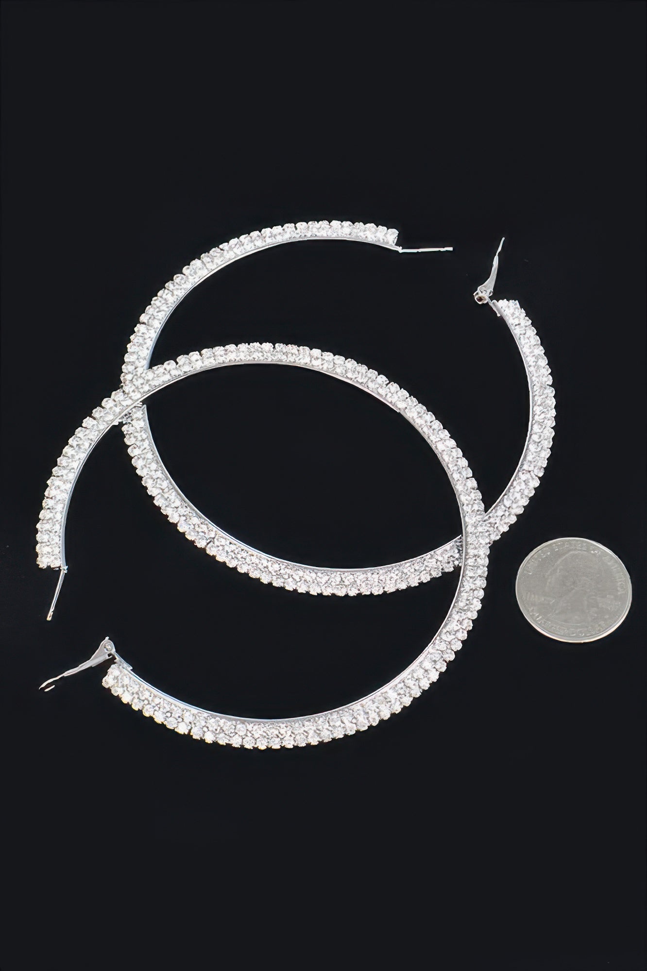 Silver-tone rhinestone hoop earrings with clear stones and visible hook posts
