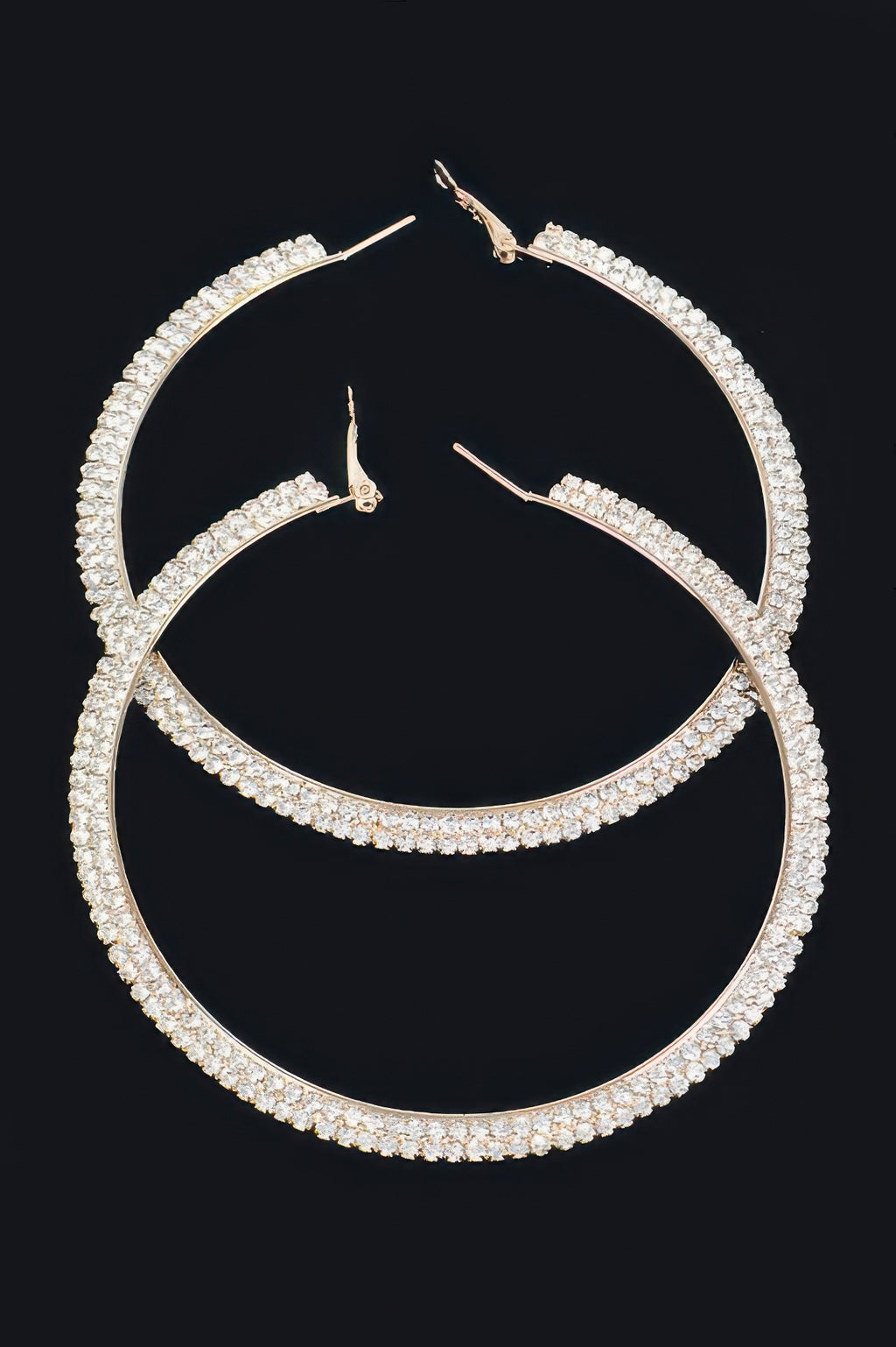 Gold-tone rhinestone hoop earrings with clear stones, curved full hoop