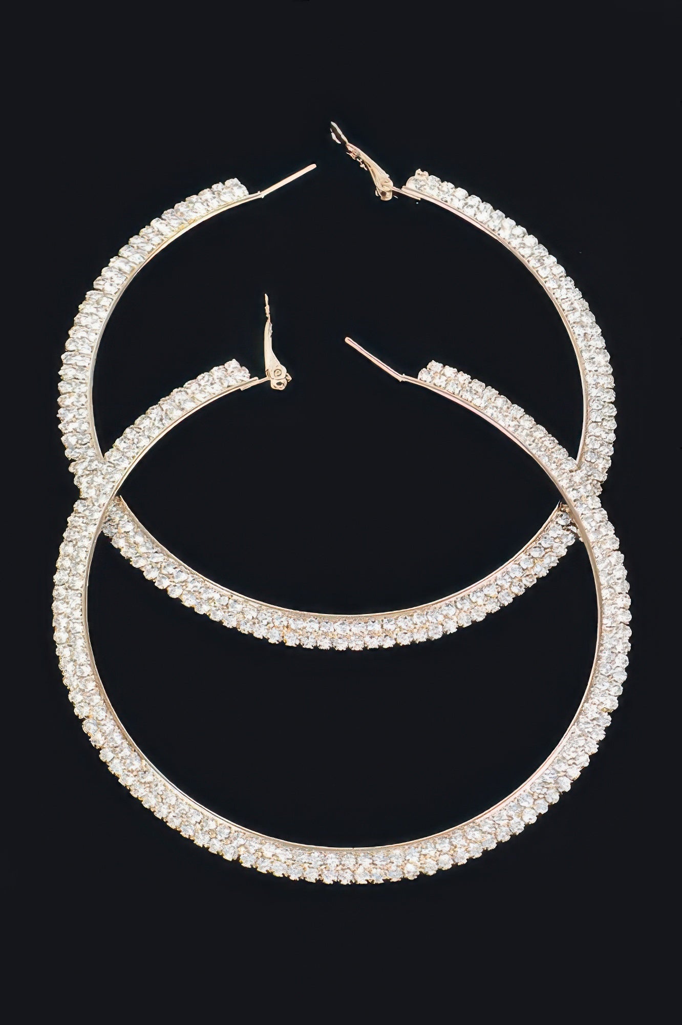 Gold-tone rhinestone hoop earrings with clear stones, curved full hoop