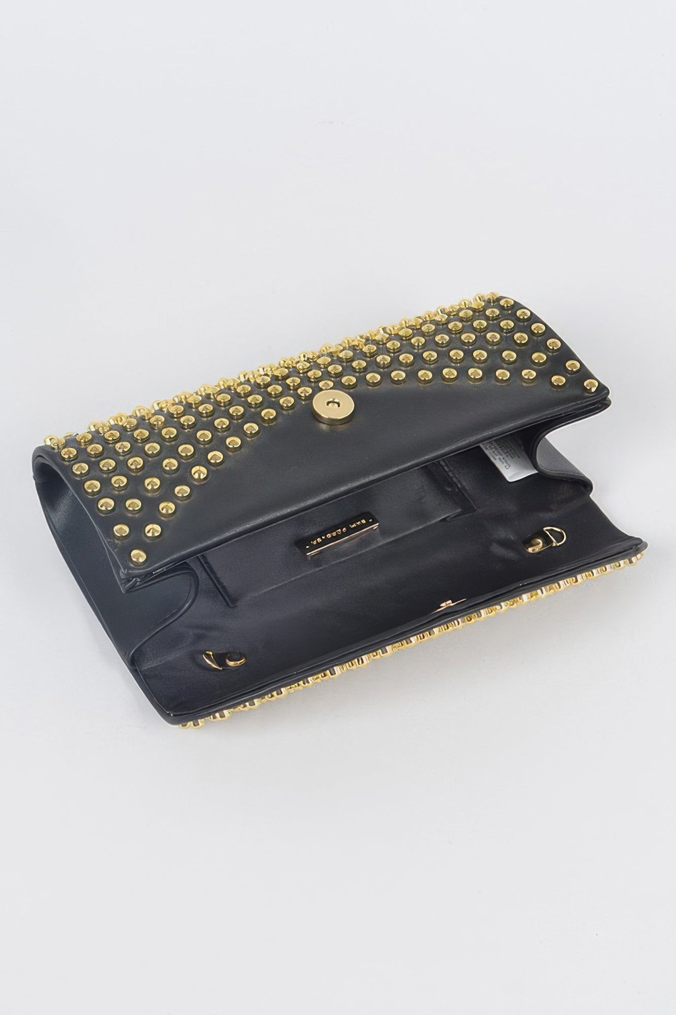 Open black studded clutch showing interior pocket and gold studded flap