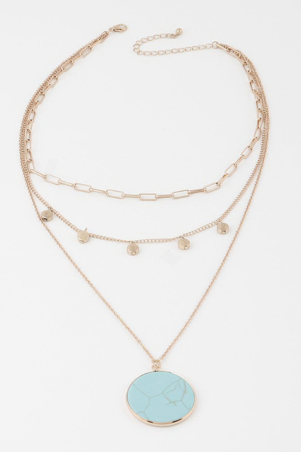Gold multi-chain pendant necklace with round turquoise disc and small coin charms