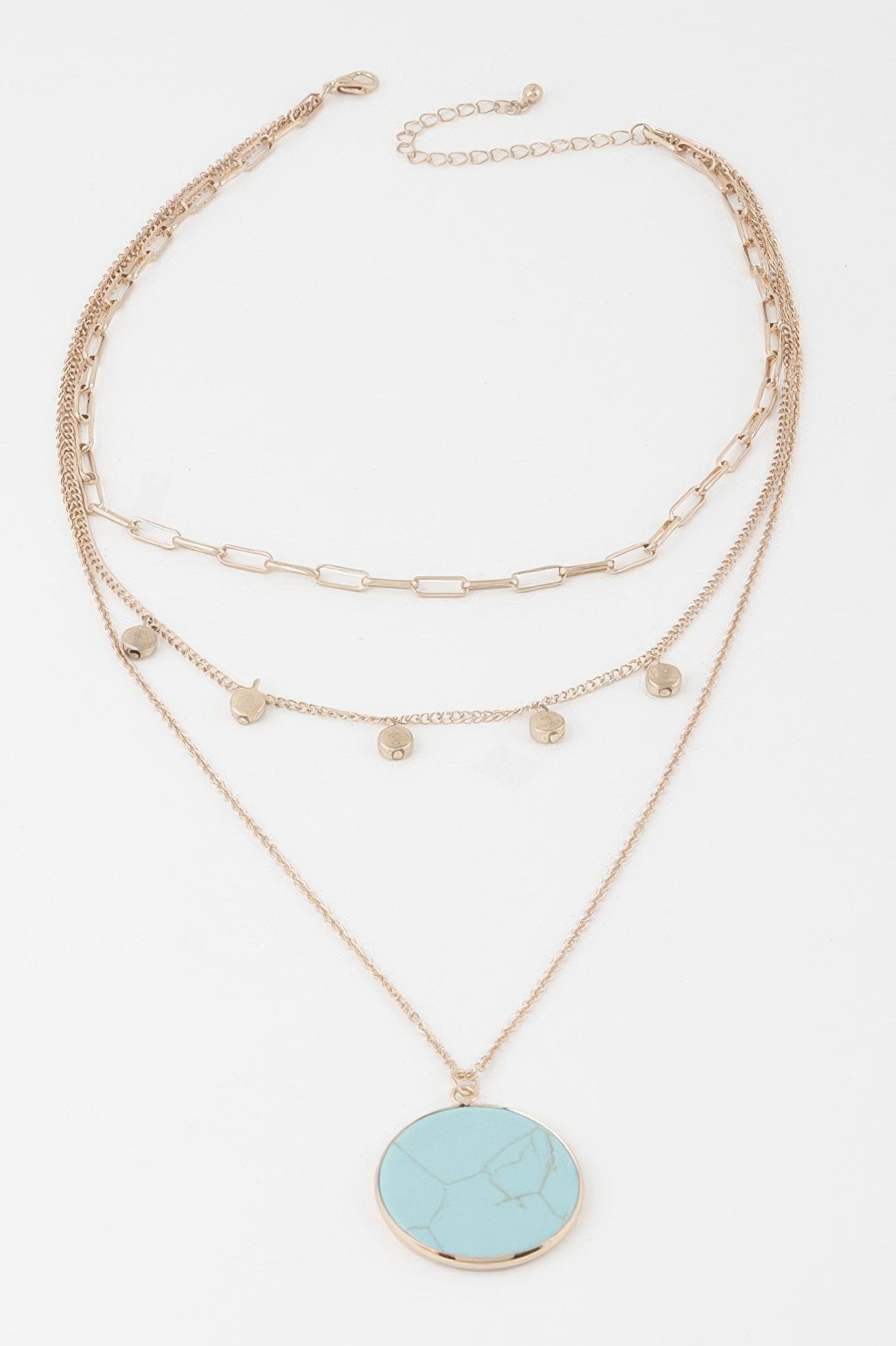 Gold multi-chain pendant necklace with round turquoise disc and small coin charms