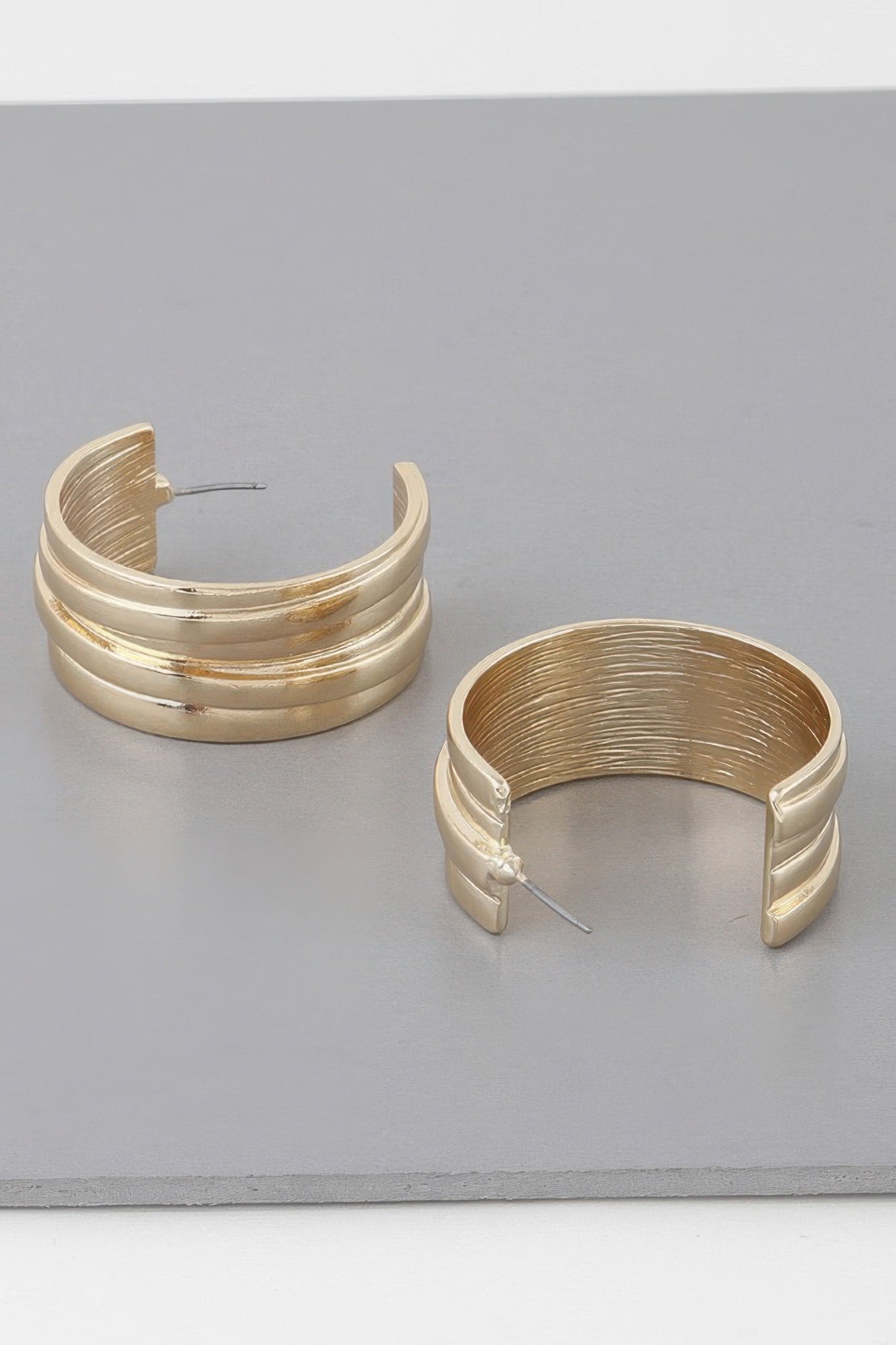 Gold multi-lined hoop earrings, curved stacked rings with straight pin backs