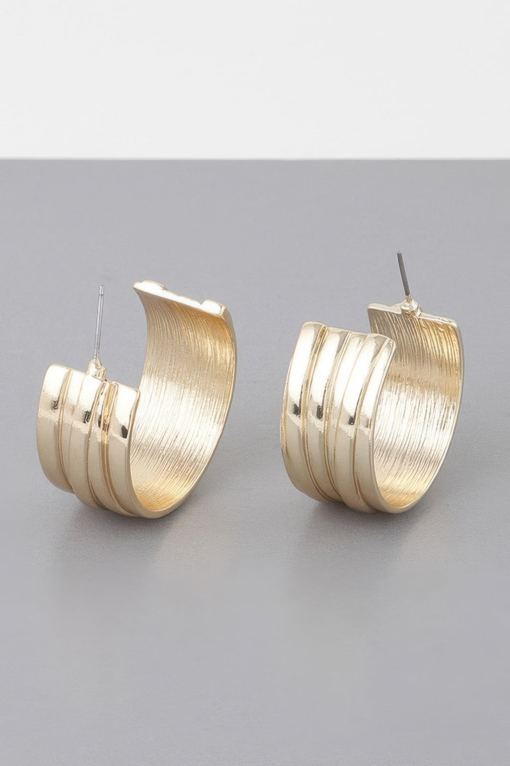 Gold textured multi-hoop earrings, three stacked bands with stud posts