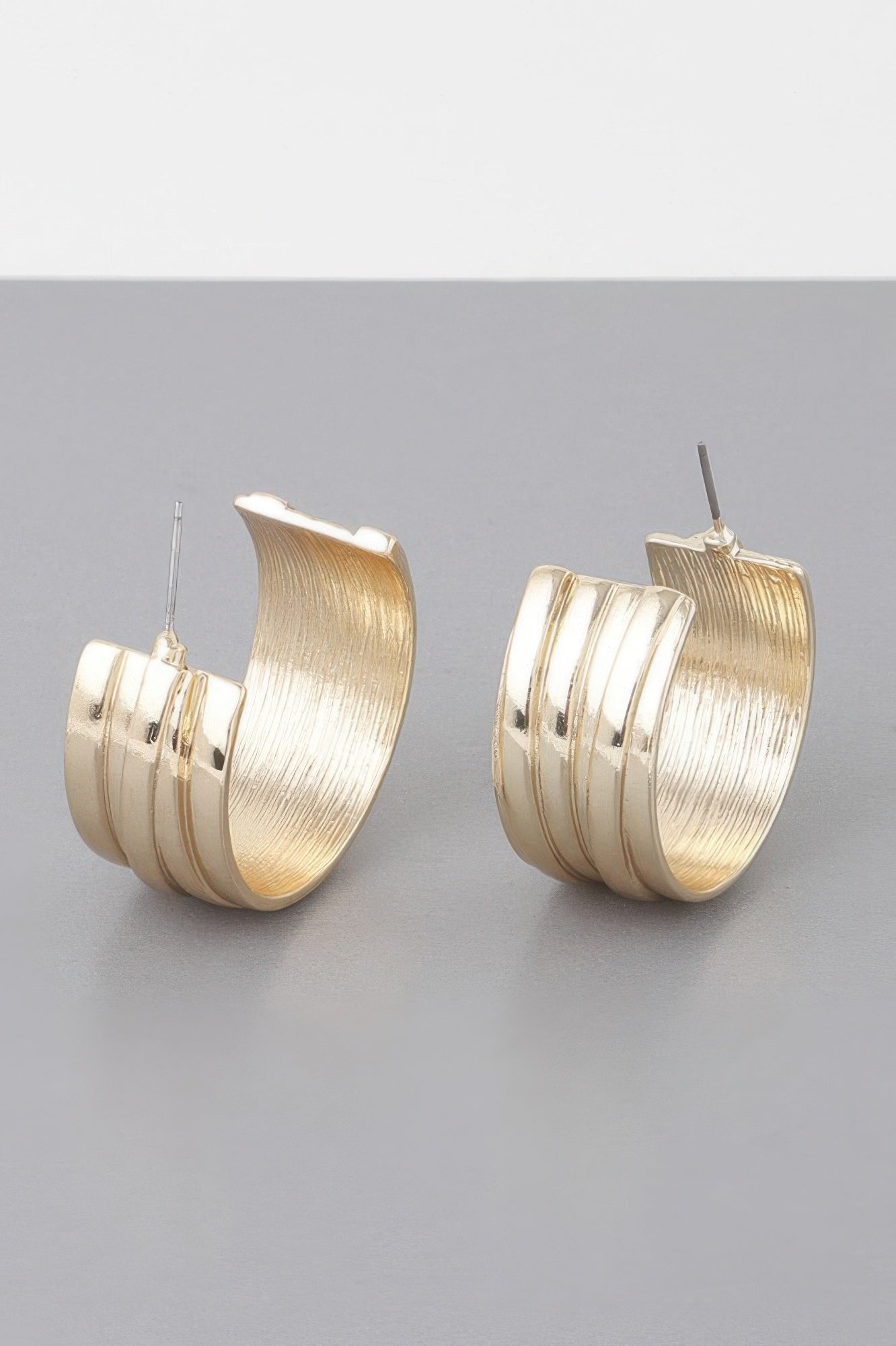 Gold textured multi-hoop earrings, three stacked bands with stud posts