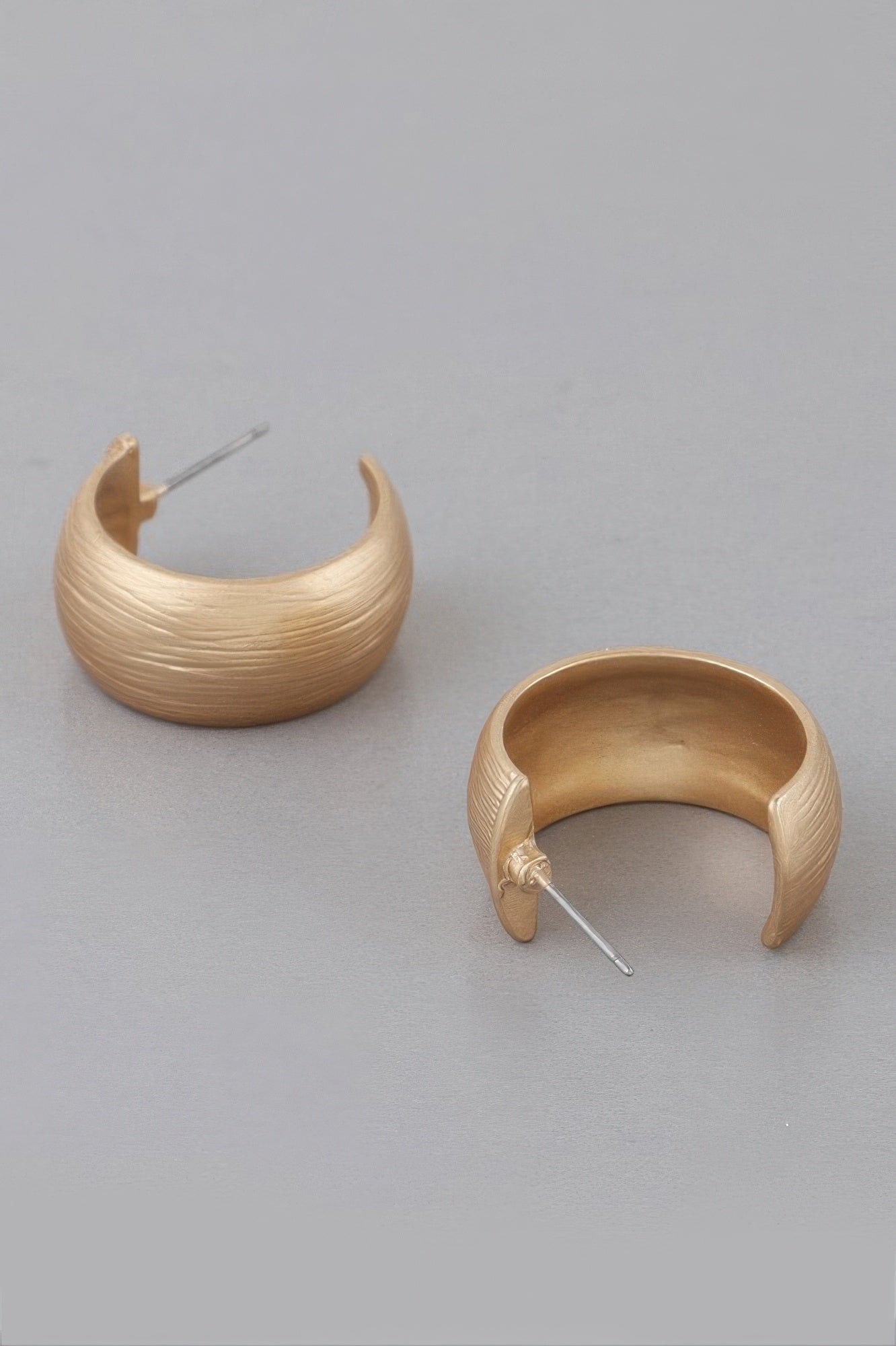 Gold-tone bulky hoop earrings, curved scraped texture and hinge-style post backs