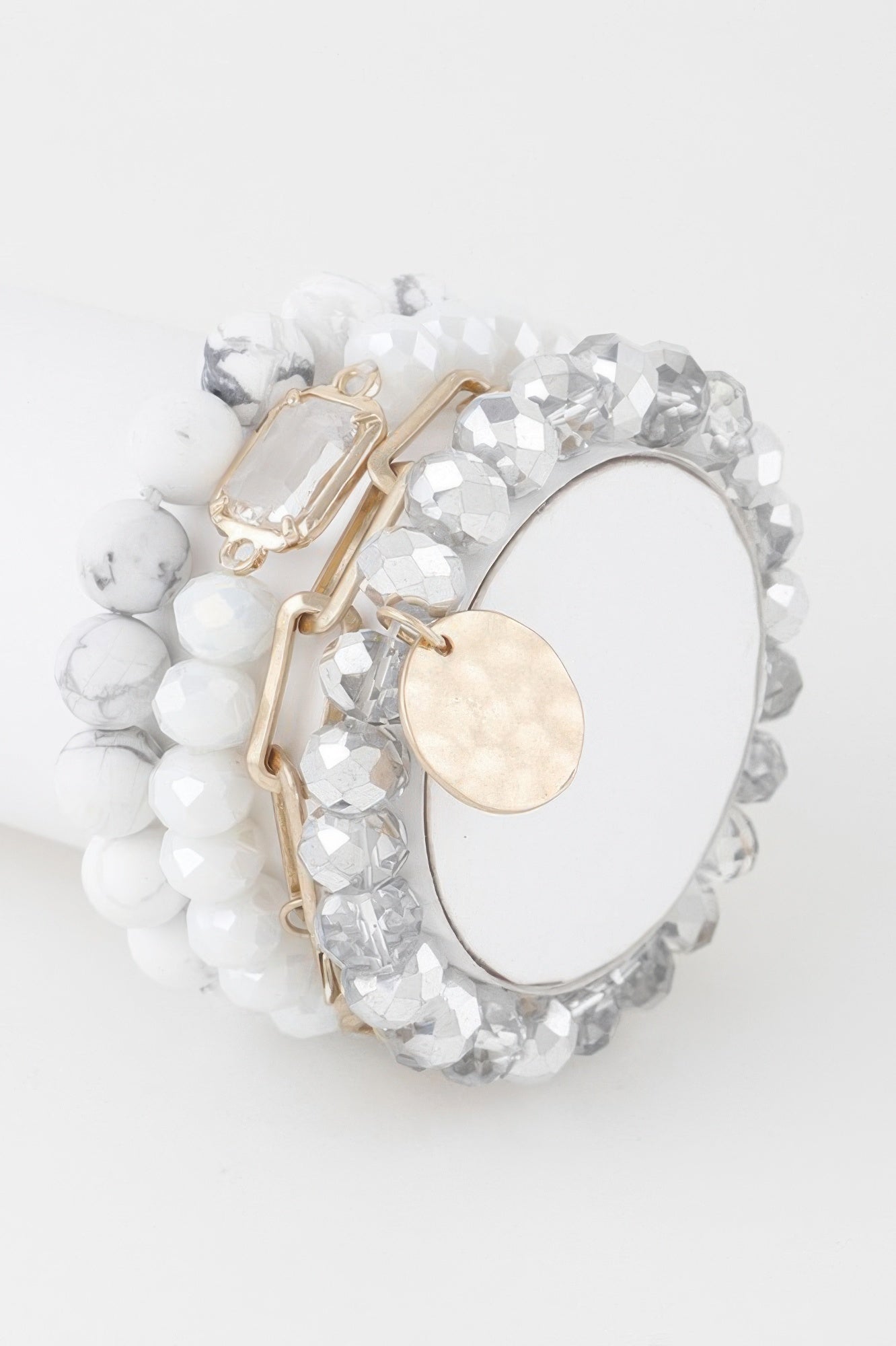 White crystal beaded bracelet with gold links and oval coin charm