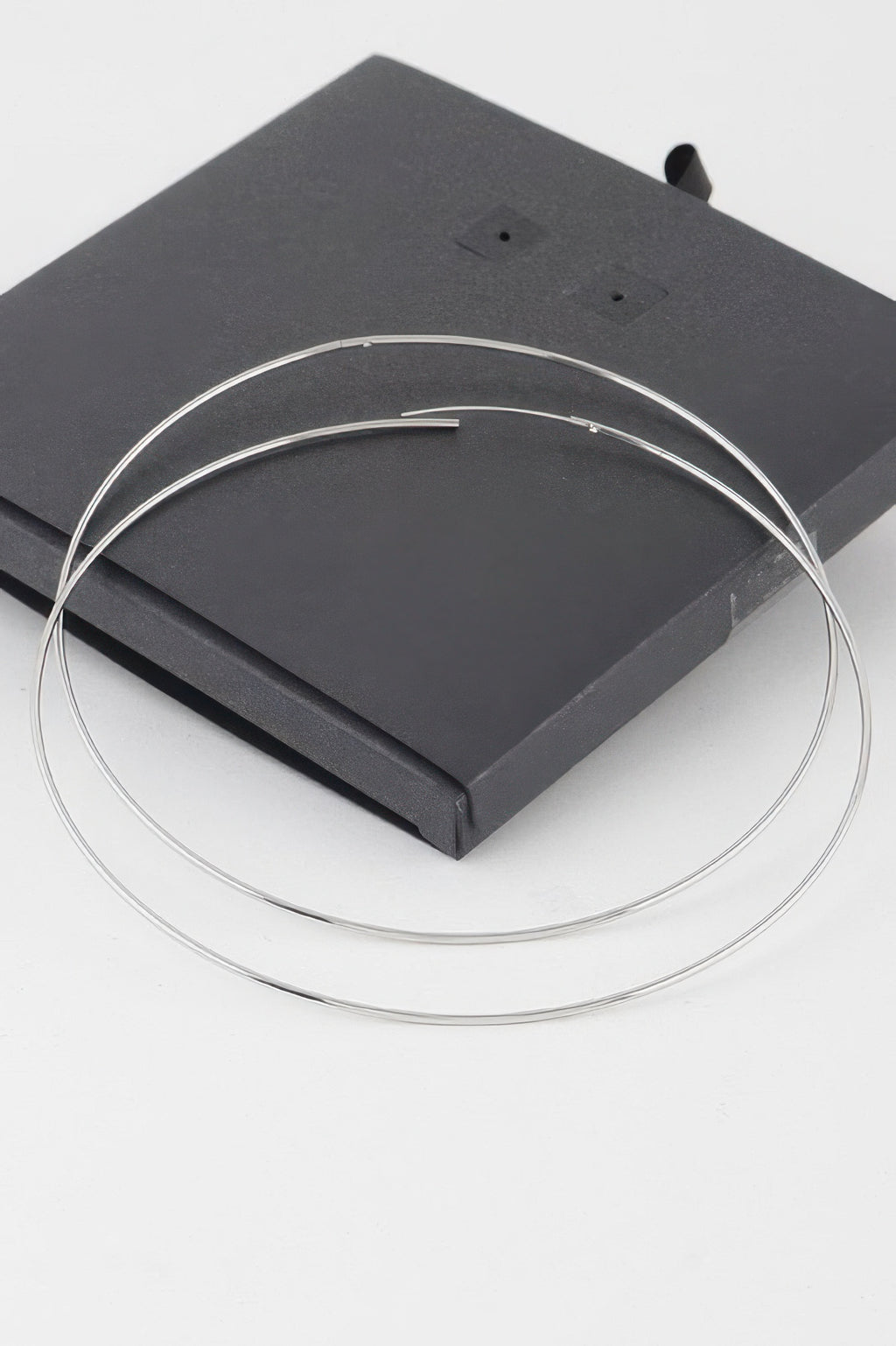 Wide silver hoops with straight posts and double loop shape
