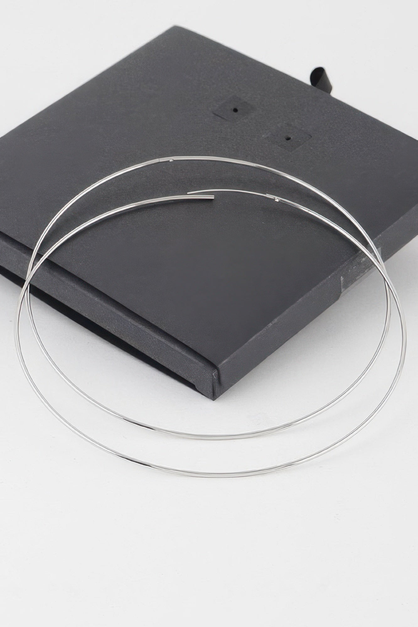 Wide silver hoops with straight posts and double loop shape