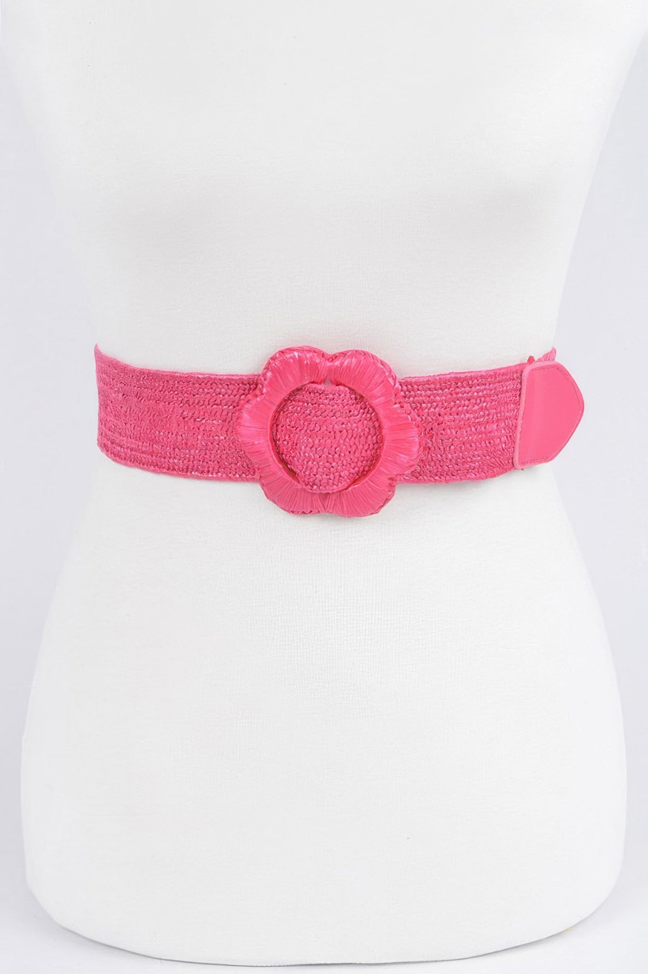 Faux straw elastic belt in fuchsia pink with fabric flower centerpiece and tab buckle