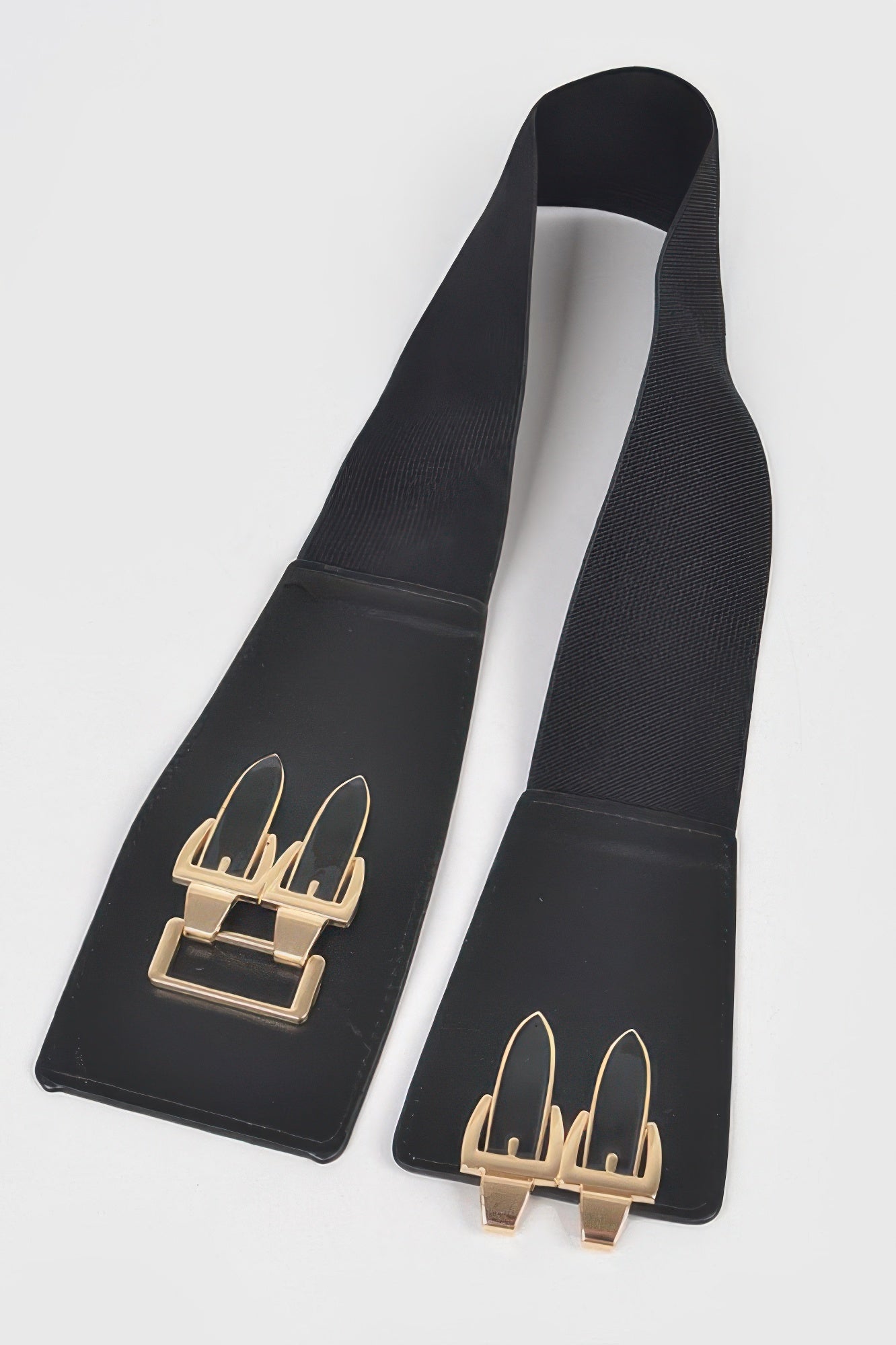 Black belt straps with gold rectangular buckle detail, flat lay