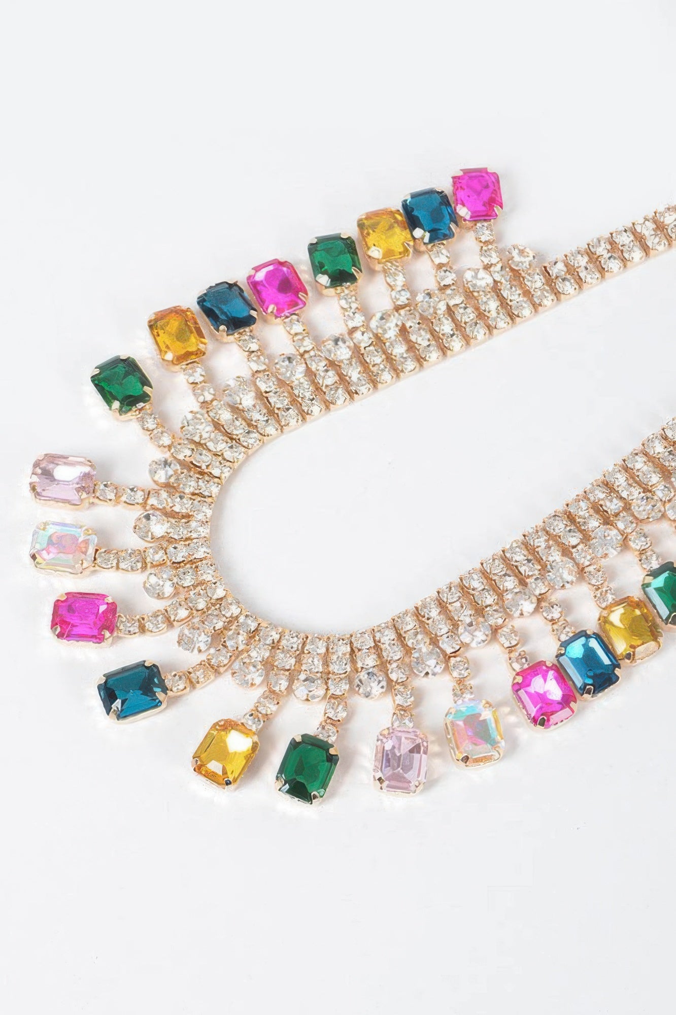 Rhinestone choker close-up: multicolor crystal drops on a gold-tone band