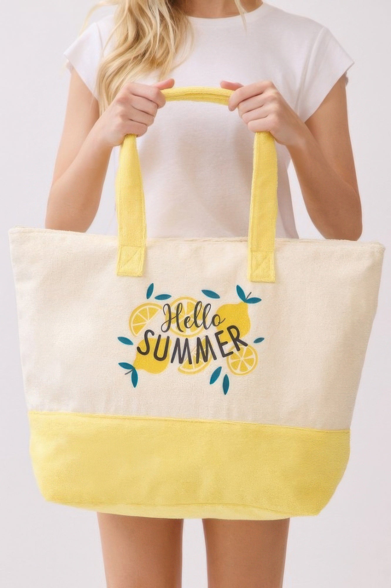 Hello Summer tote with cream fabric, yellow handles, and “Hello Summer” floral logo