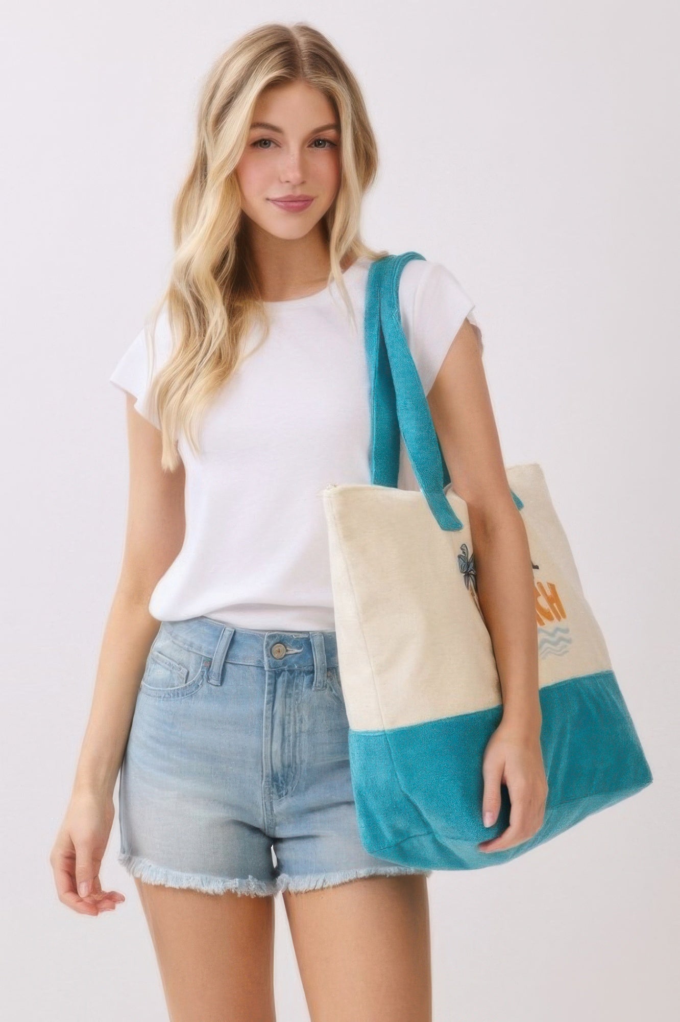 Take Me To The Beach terry tote with teal handles, cream front panel and logo