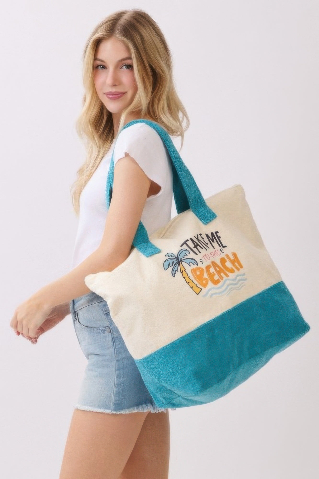 Take Me To The Beach tote bag in cream and teal, front logo print visible