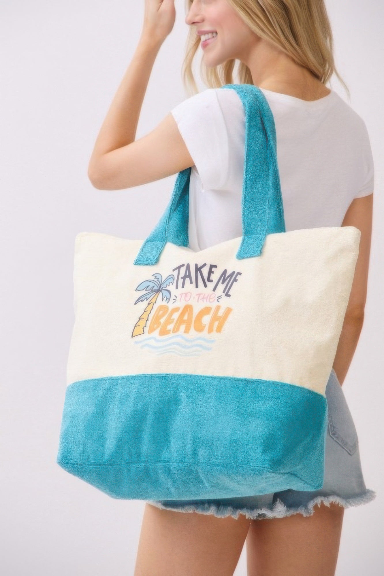 Take Me To The Beach tote bag from side view, cream top and teal textured bottom