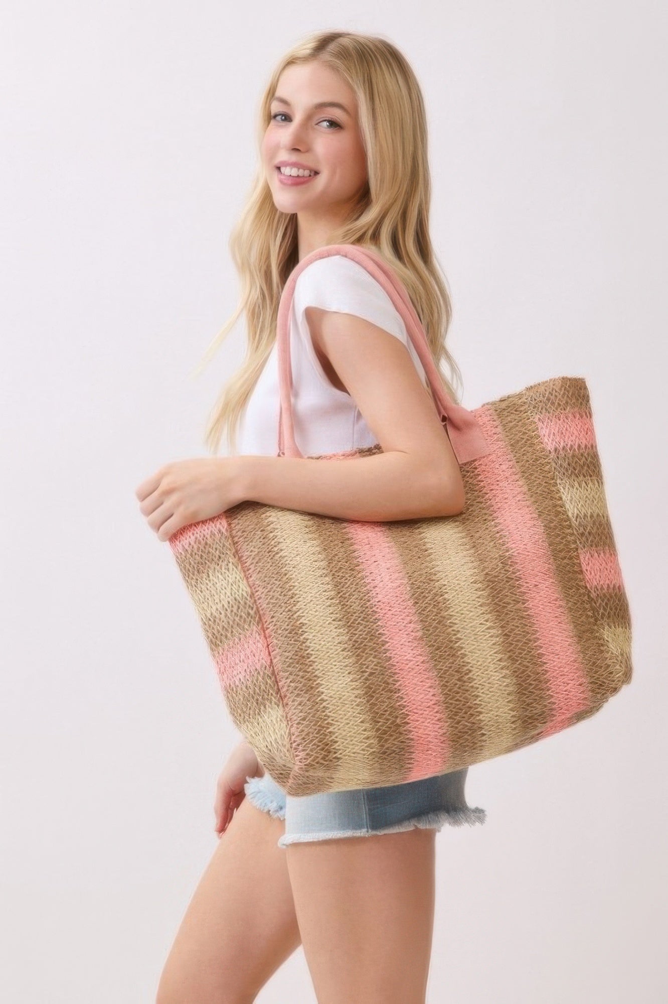 Natural brown straw tote with pink striped pattern and pink rope handles