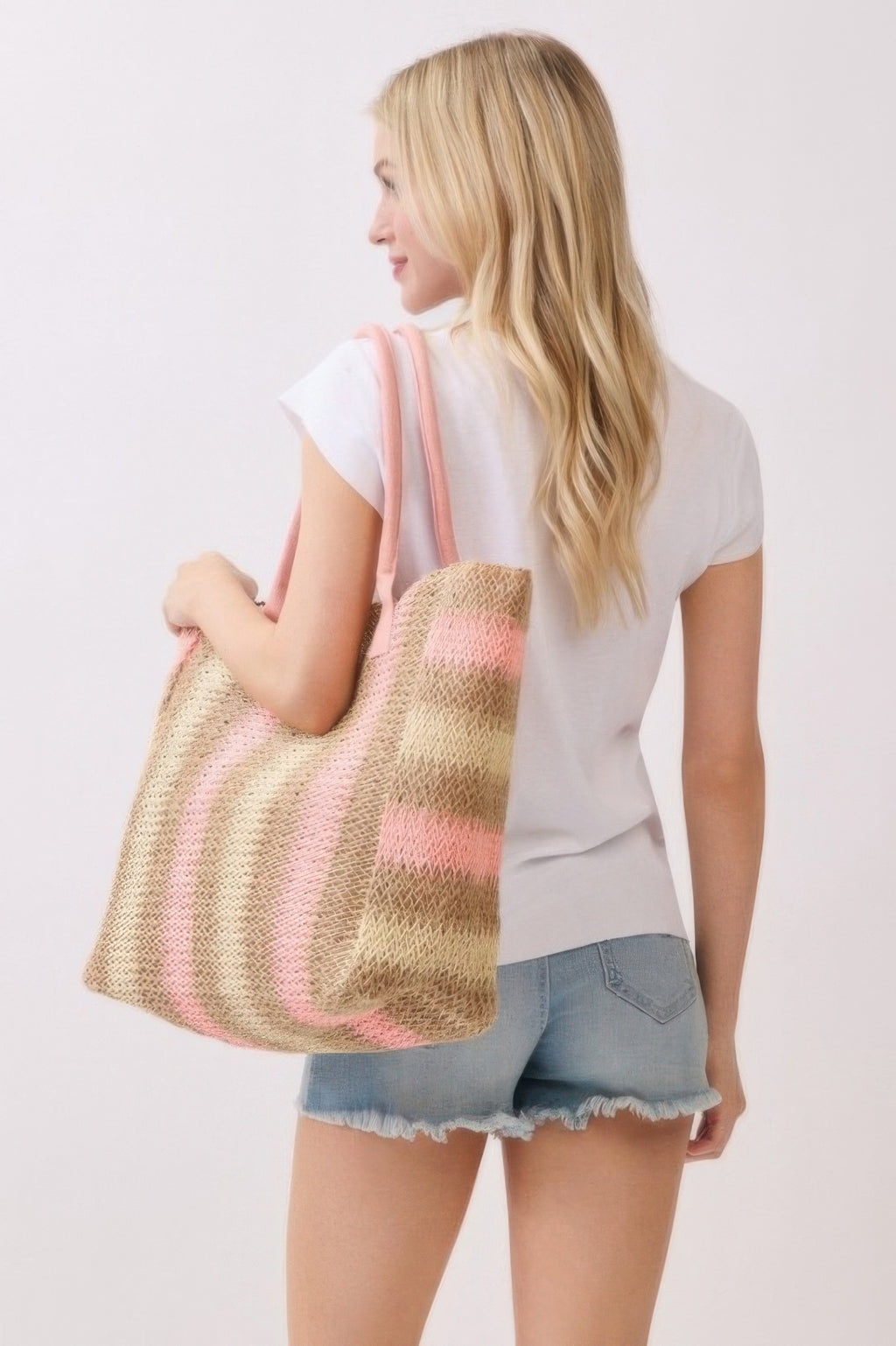 Straw tote bag with multi-color vertical stripes and pink handle straps