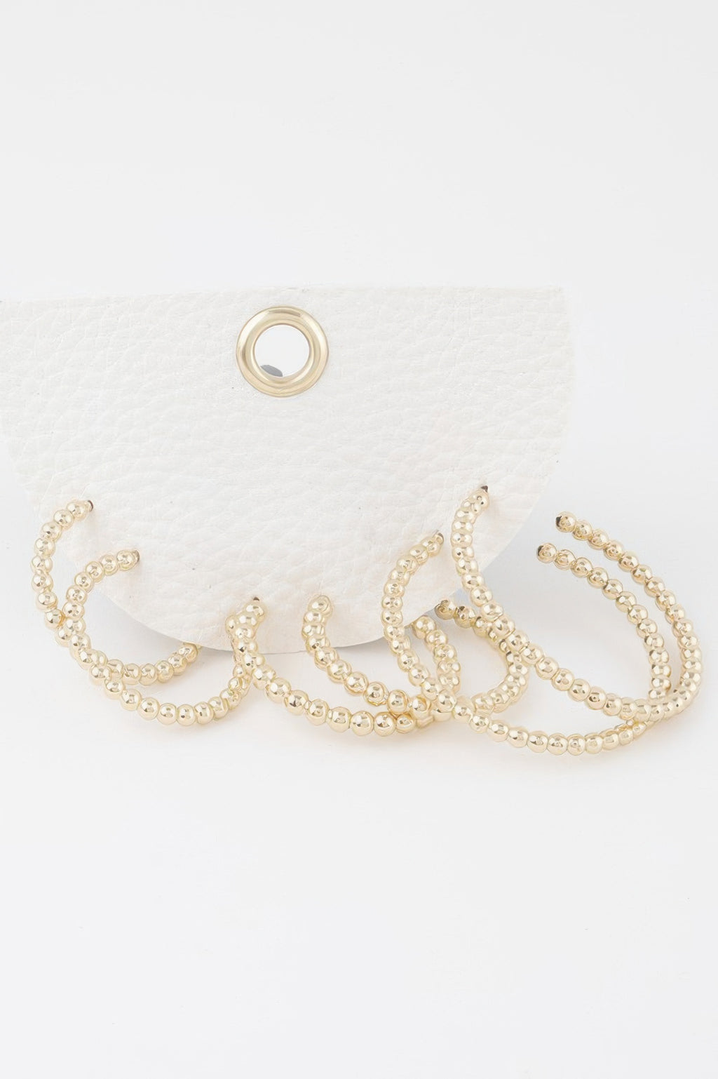 Gold pearl bead open hoop earrings set with scalloped bead detail