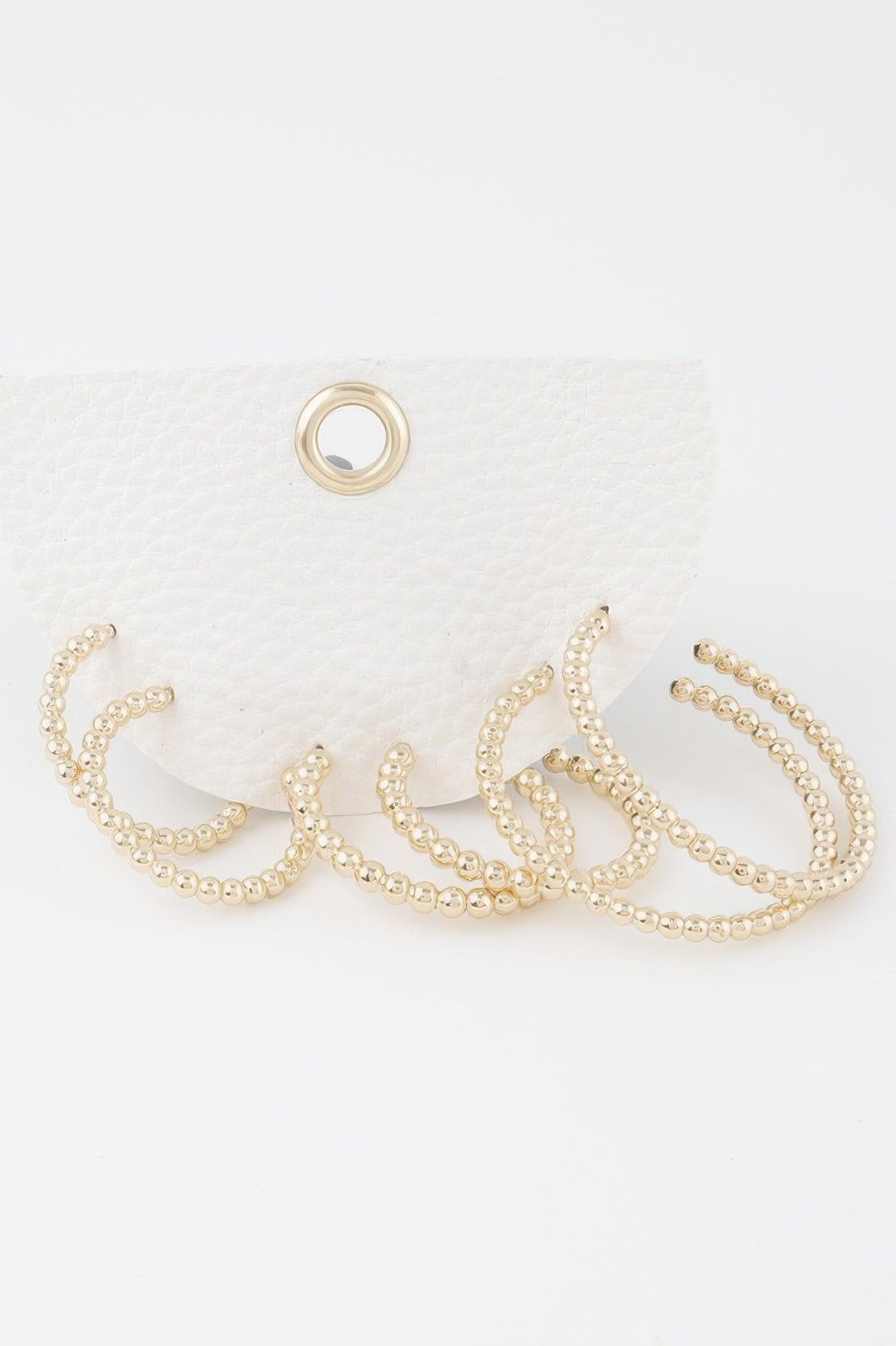 Gold pearl bead open hoop earrings set with scalloped bead detail