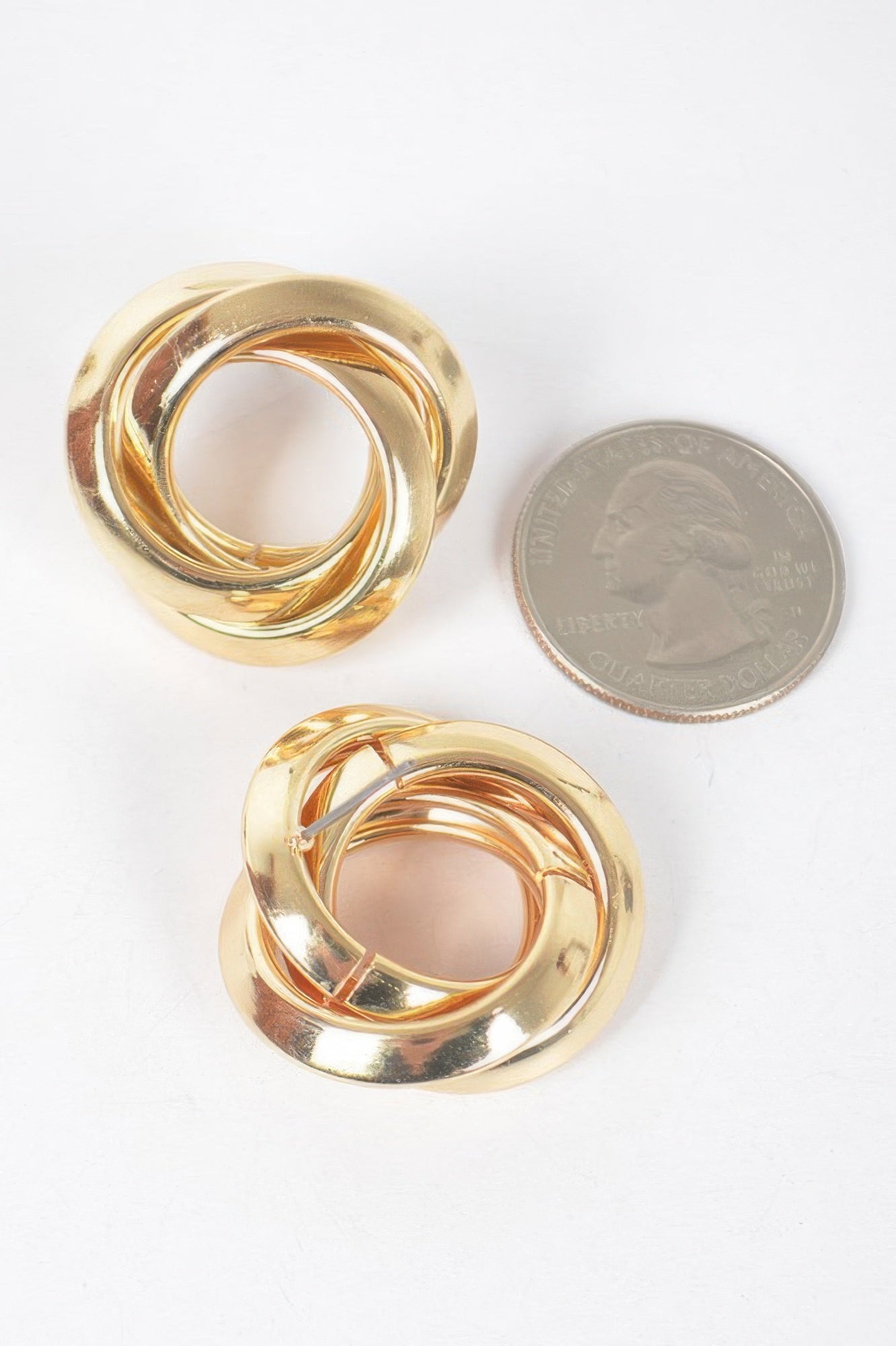 Gold stud earrings, shiny twisted loop pattern in round bezel