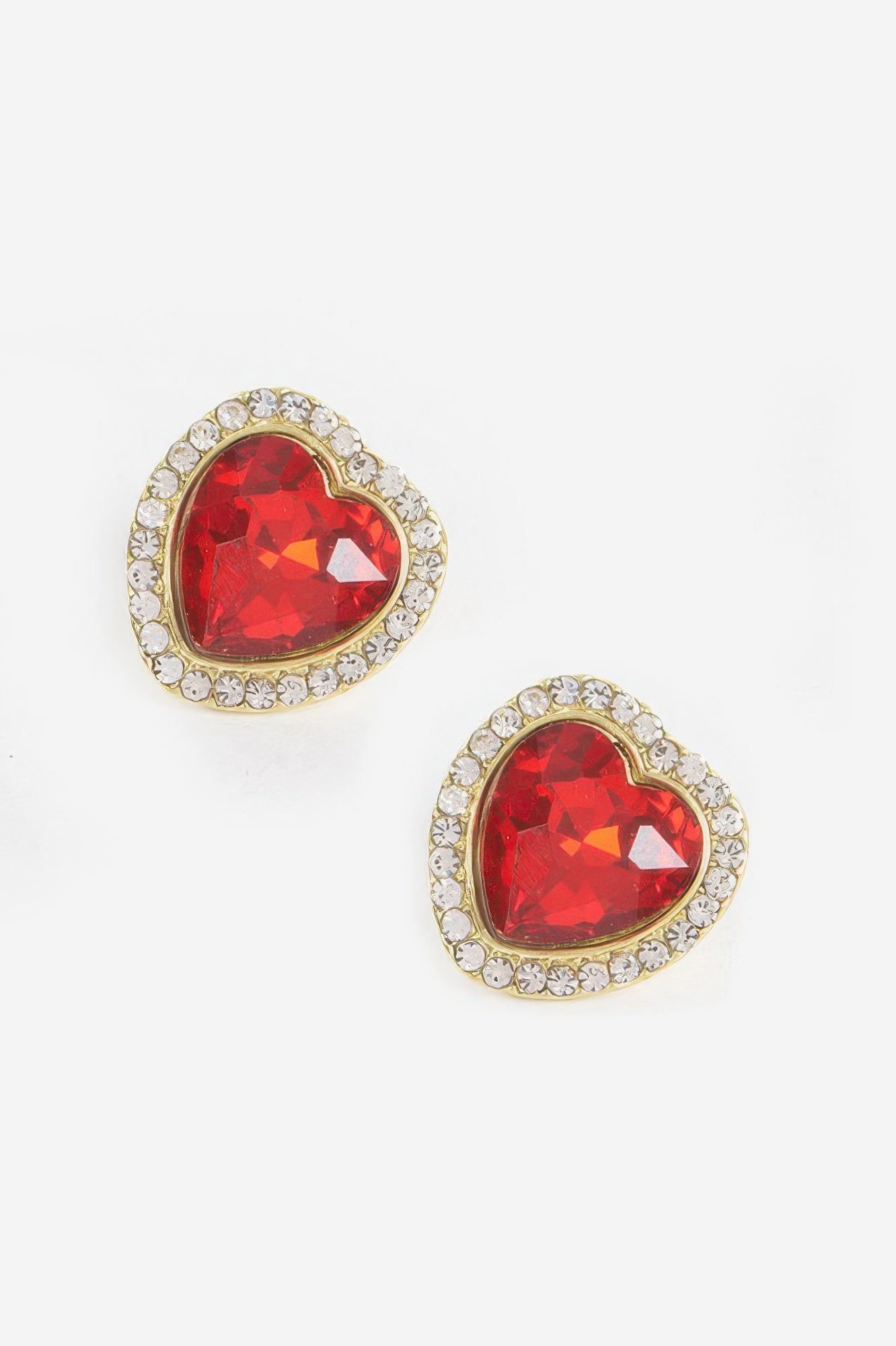 Heart-shaped stone earrings with red gem and gold-tone crystal border