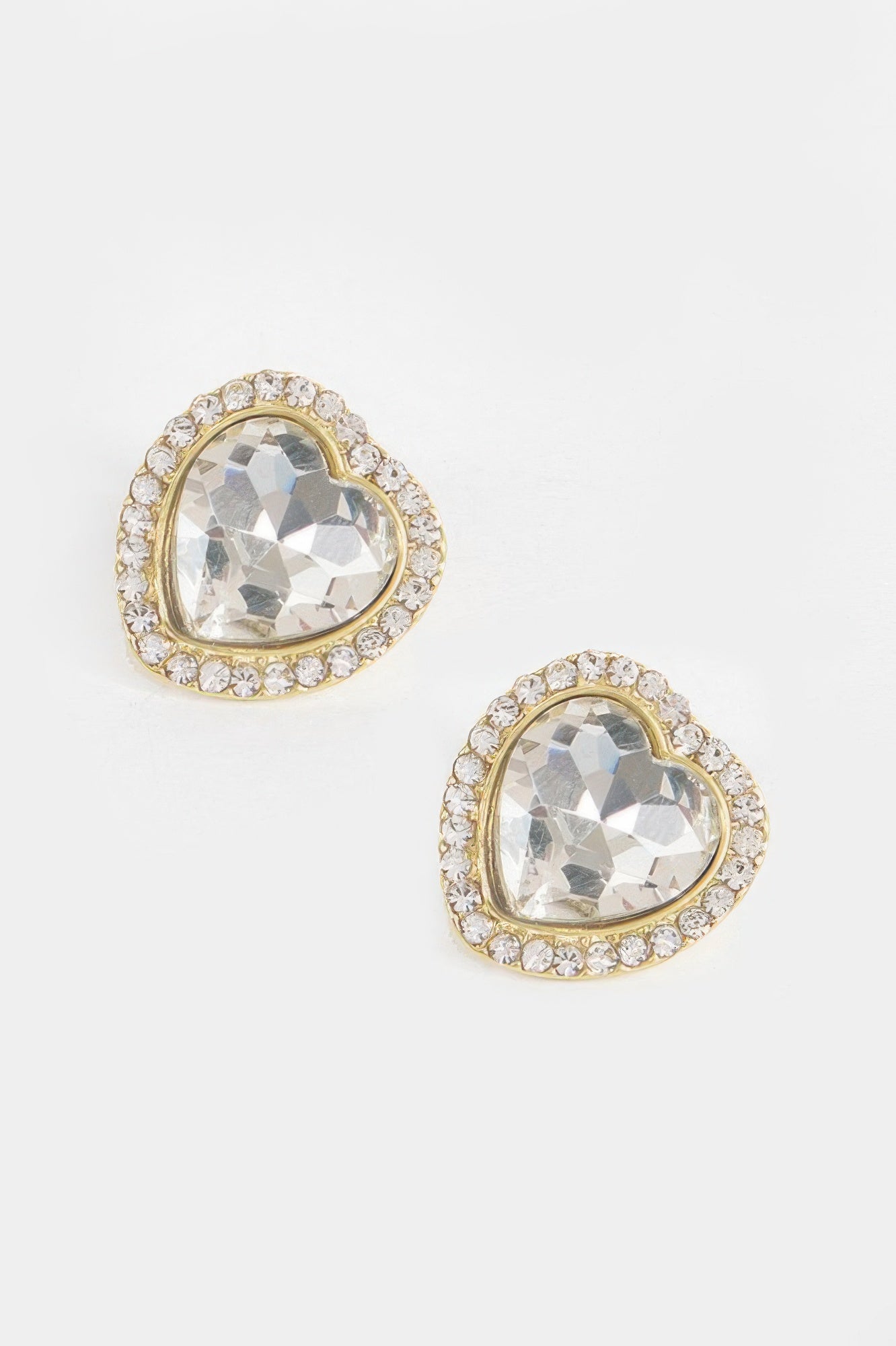 Heart-shaped stone earrings with clear/white gem and gold-tone crystal halo