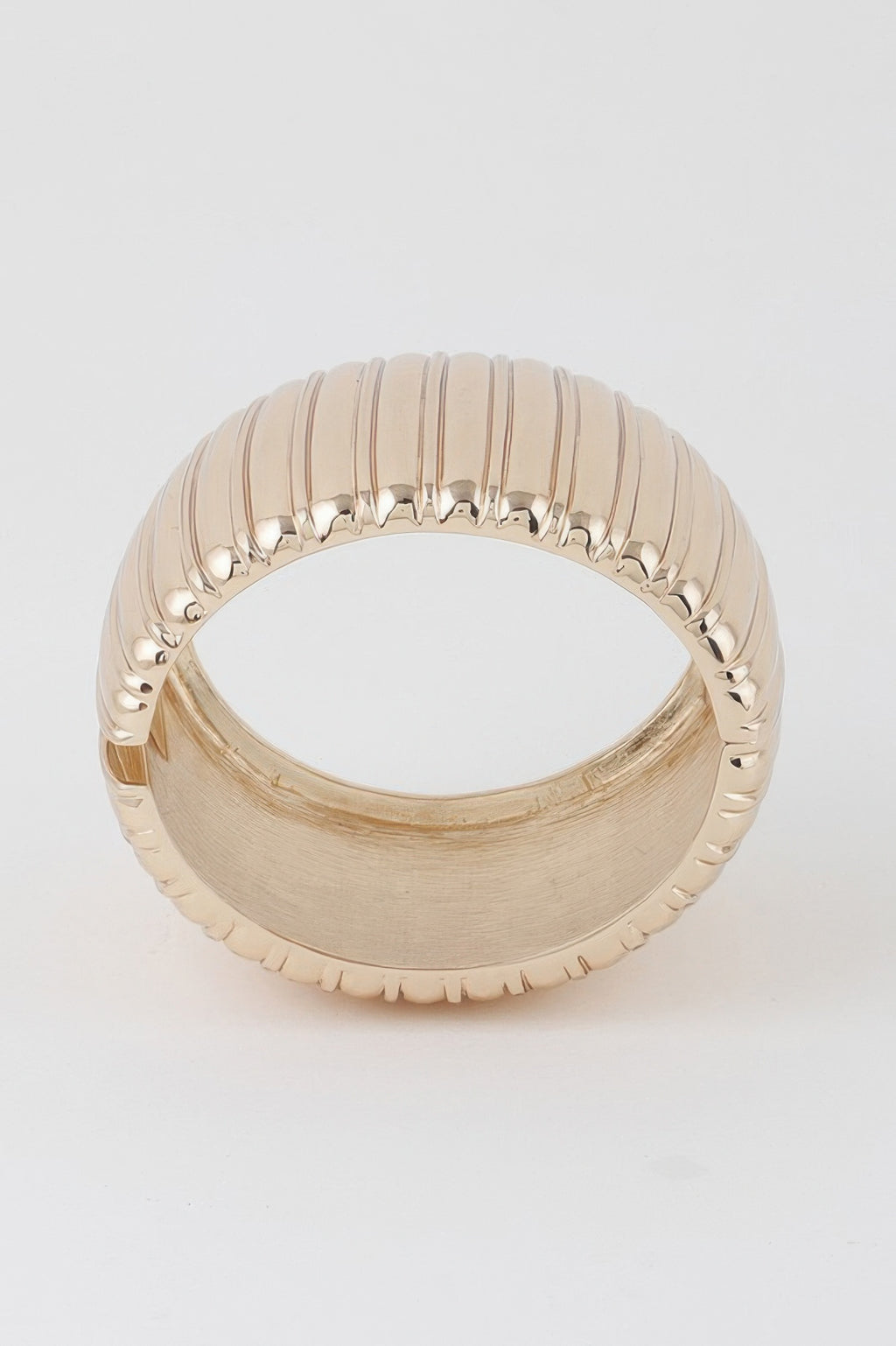 Gold wide ribbed cuff bracelet, open circular profile.