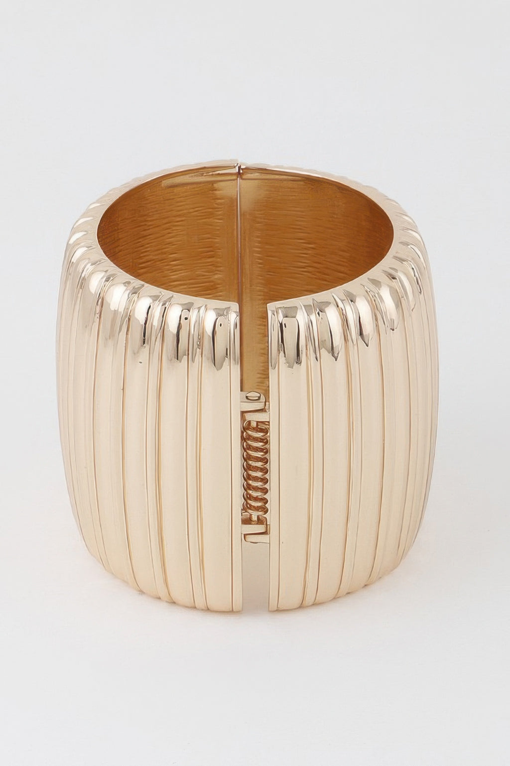 Gold wide ribbed cuff bracelet, front view with clasp and spring detail.