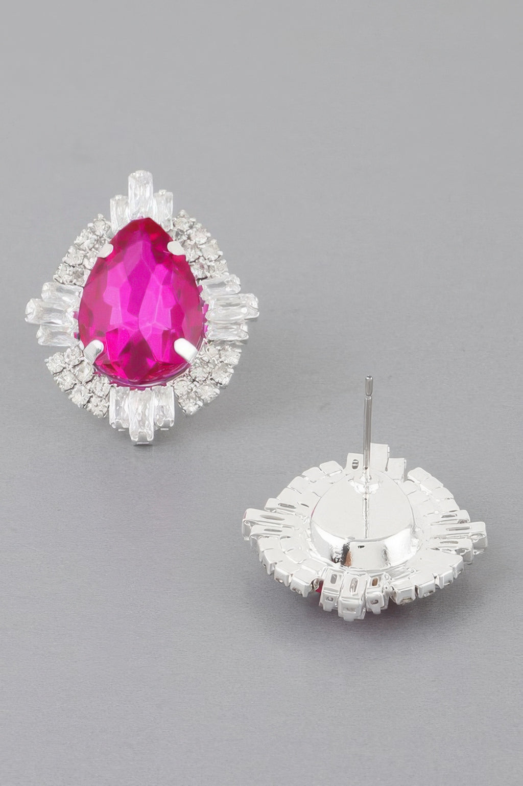 Fuchsia teardrop crystal stud earrings with silver-toned halo; shows earring backs