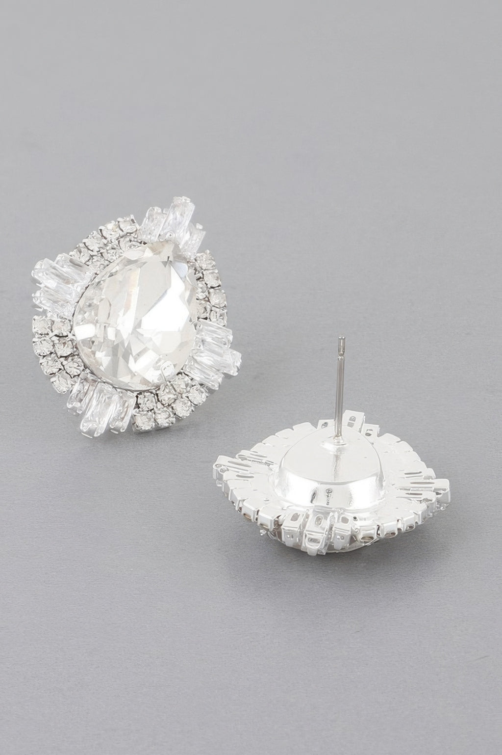 Jeweled teardrop crystal stud earrings with clear crystal center and silver-toned setting