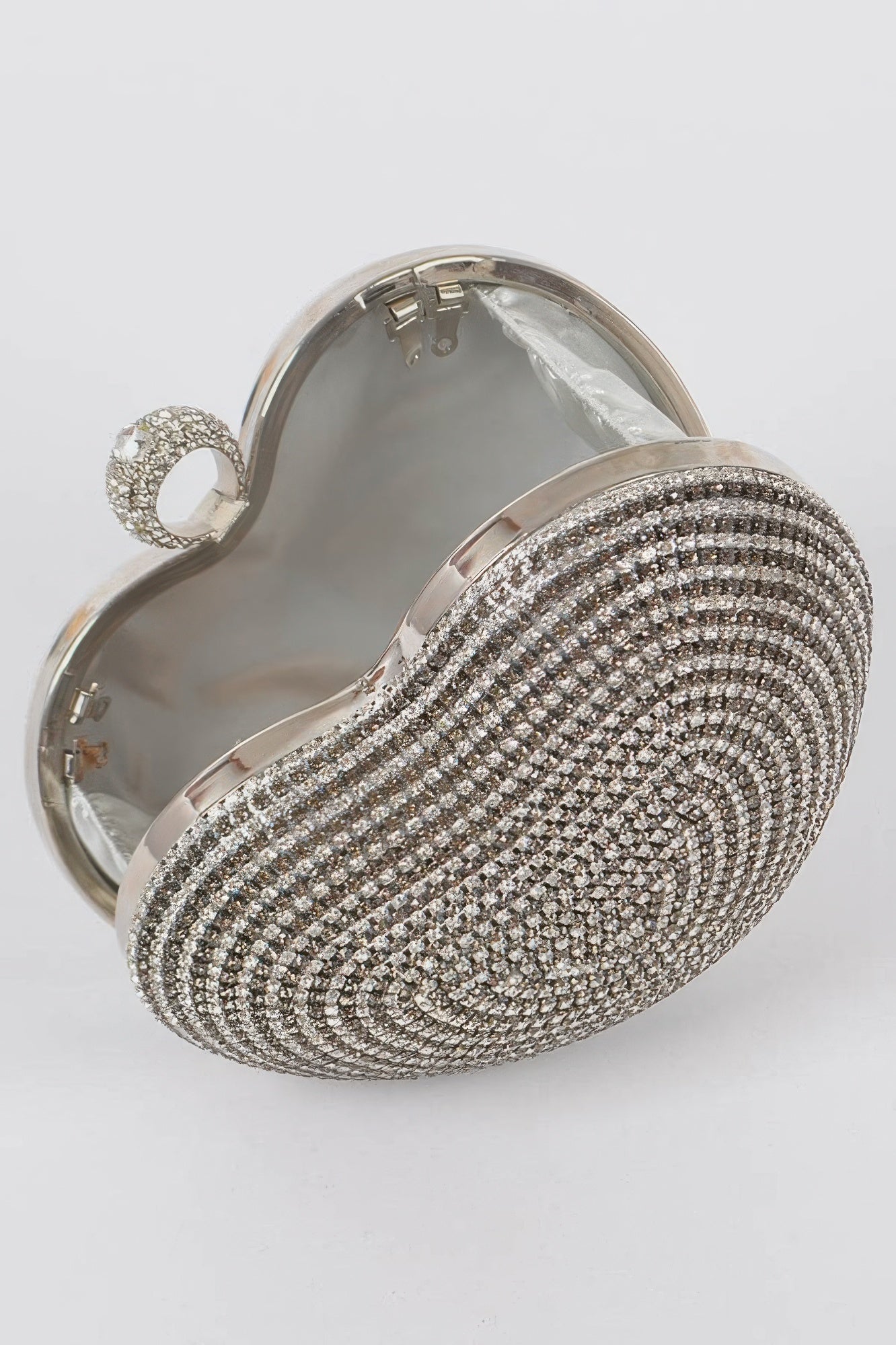 Silver heart rhinestone clutch open view with inner lining and curved metal frame