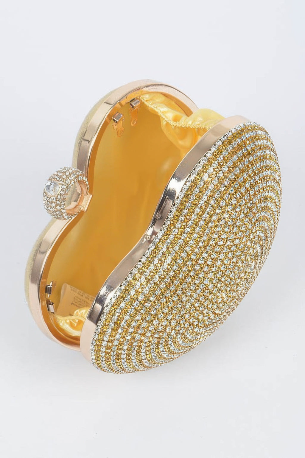 Gold rhinestone heart clutch open with satin-lined interior and curved metal frame